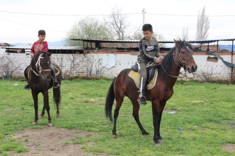 Çocuklar sokağın keyfini atlarla çıkarıyor
